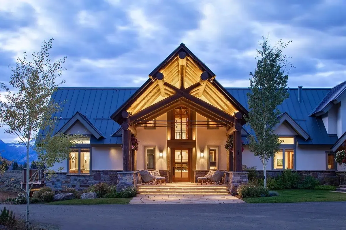 Front porch of Panorama House with exposed log beams and warm architectural lighting