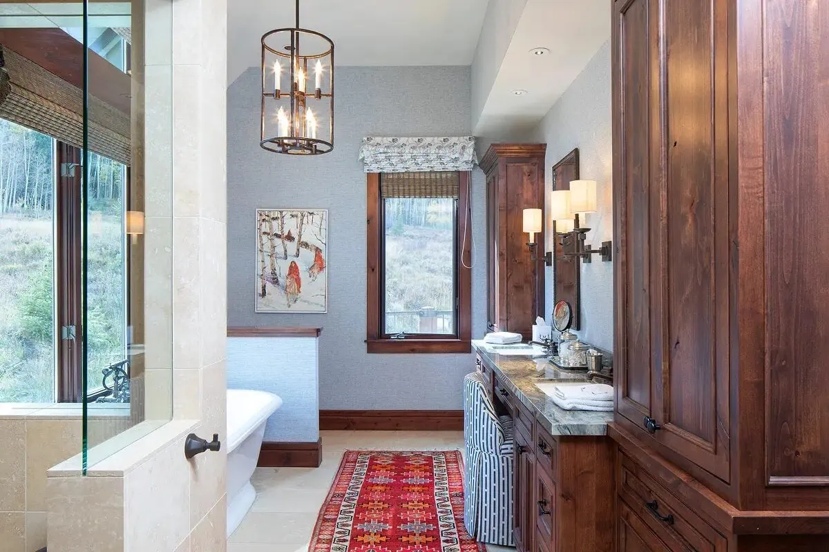 Bathroom with warm wood cabinetry, soaking tub, and mountain-facing windows