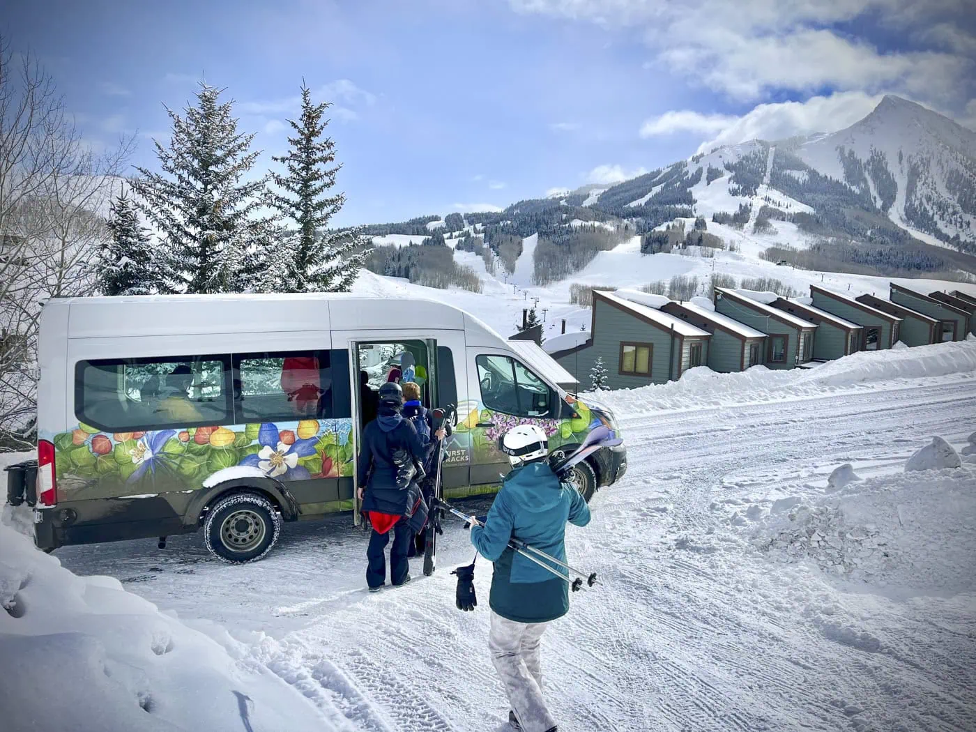 A FirstTracks van with Mt. Crested Butte behind it