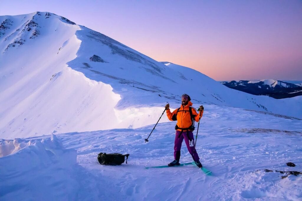 Grand Traverse racer on top of Star Pass at sunrise, photo courtesy Crested Butte Nordic